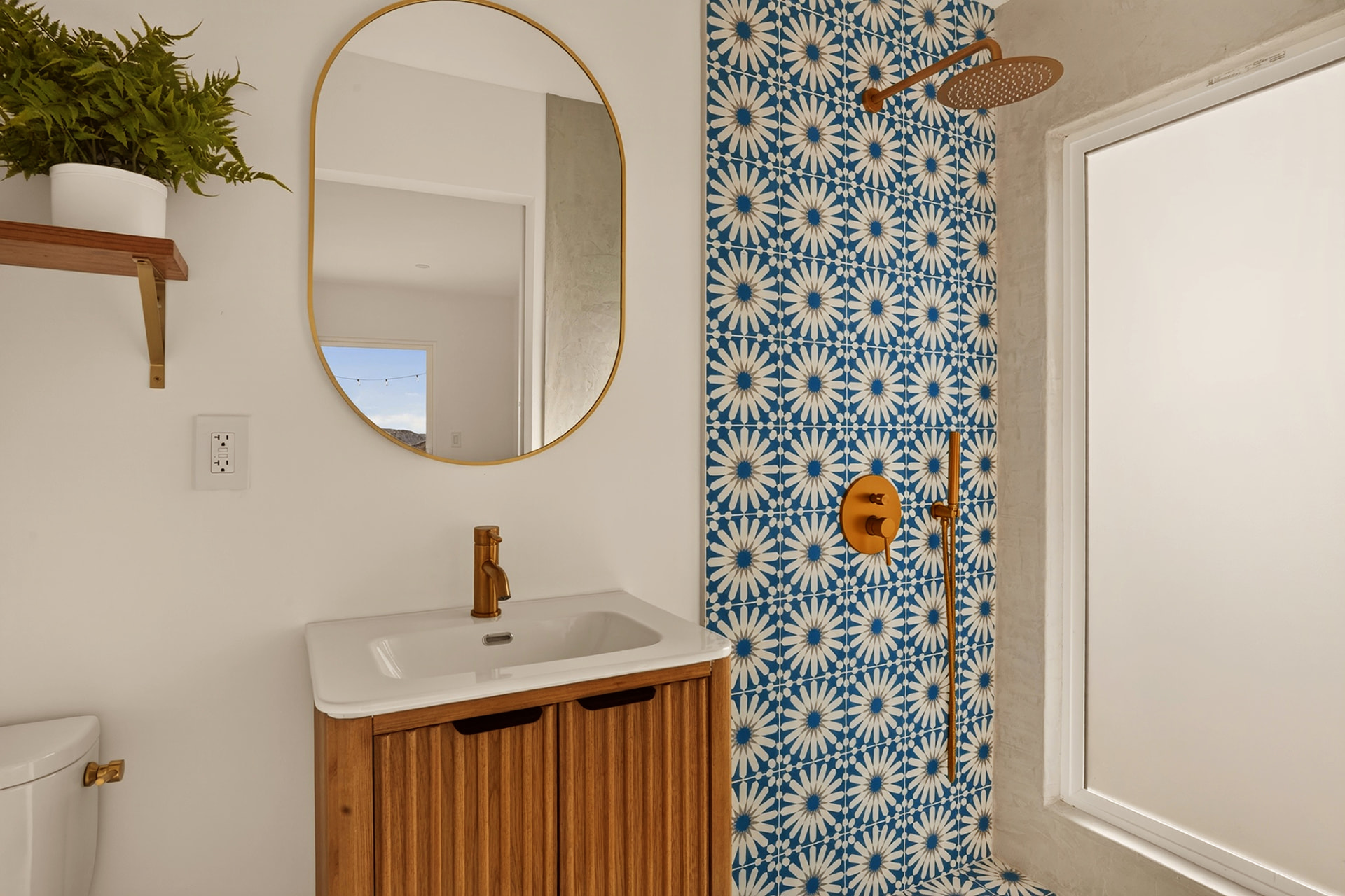 Bathroom with rain shower head and blue patterned cement tile