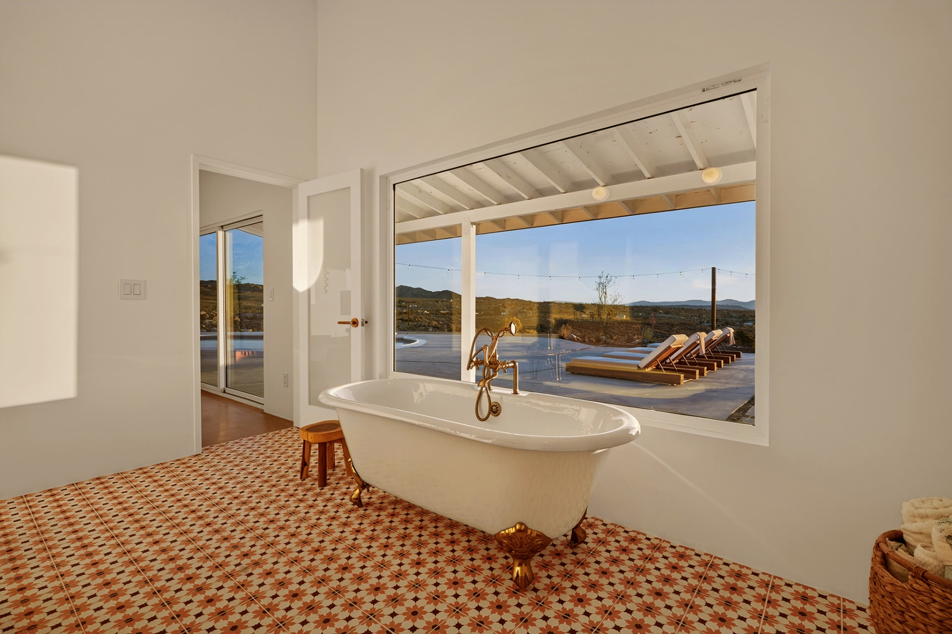 Clawfoot soaking tub beneath a garden window