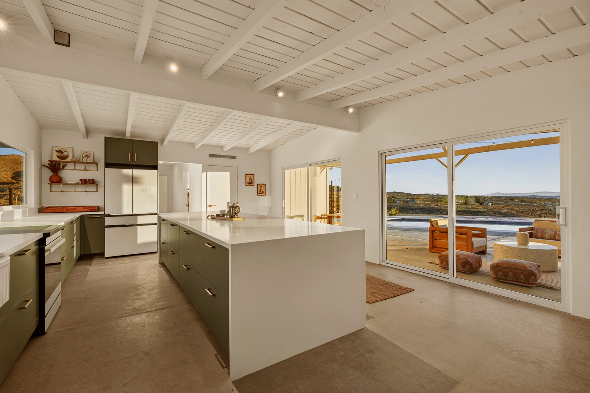 Kitchen looking out to the pool deck and desert vista