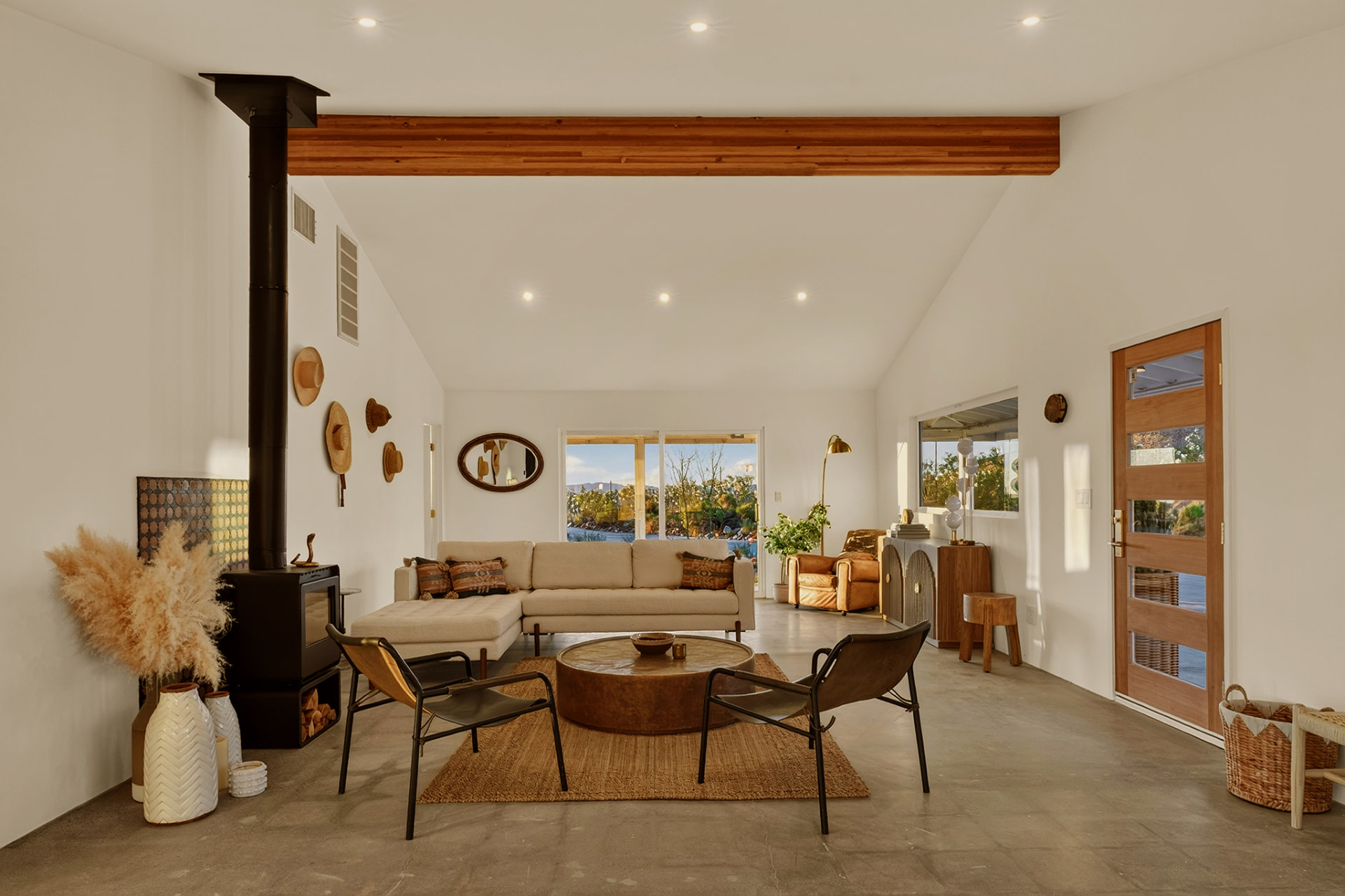 Living room with wood beam, wood stove and sectional sofa