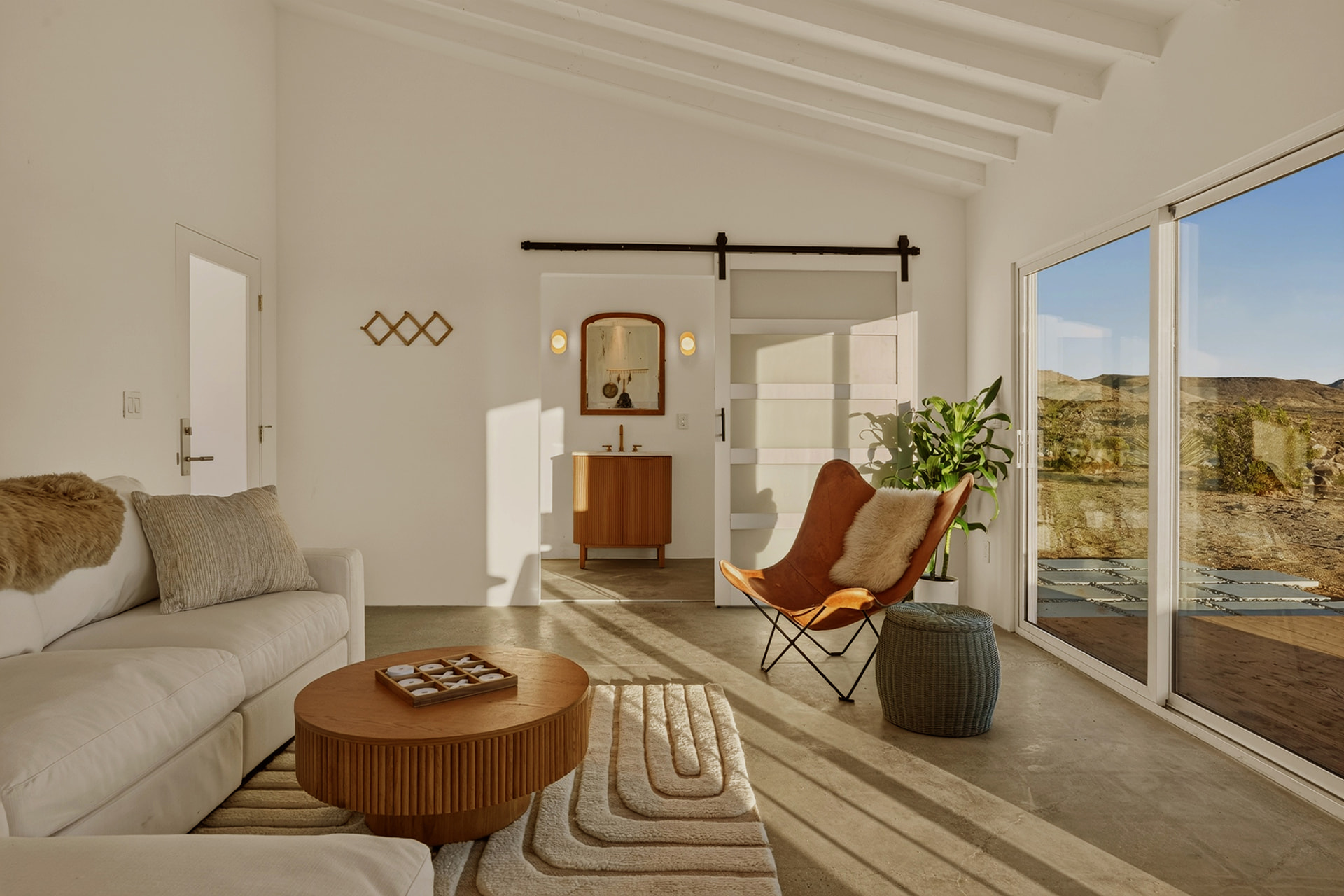 Casita living room with barn door to the bathroom and mountain views