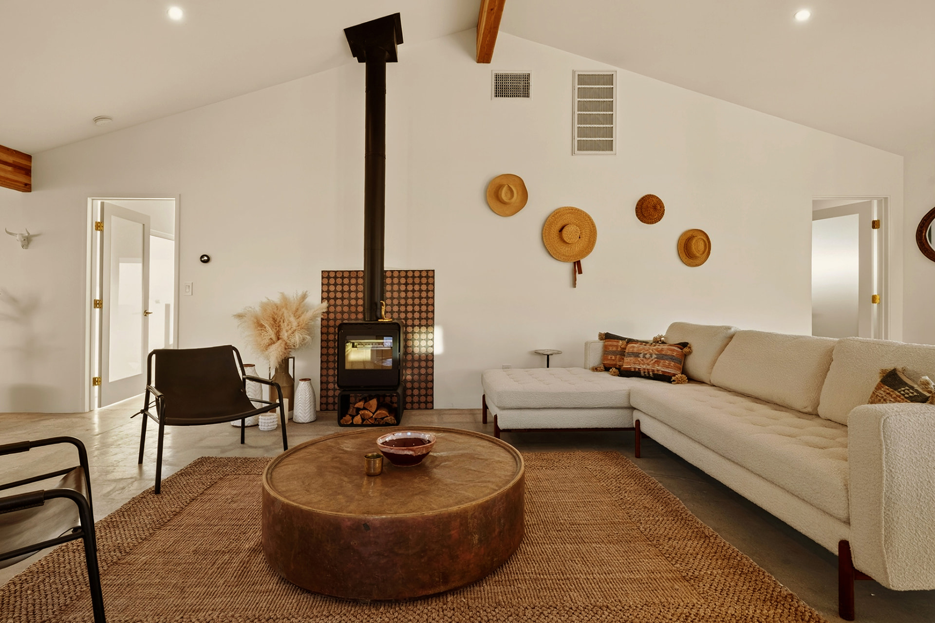 Living room with hats on the wall and bouclé sectional
