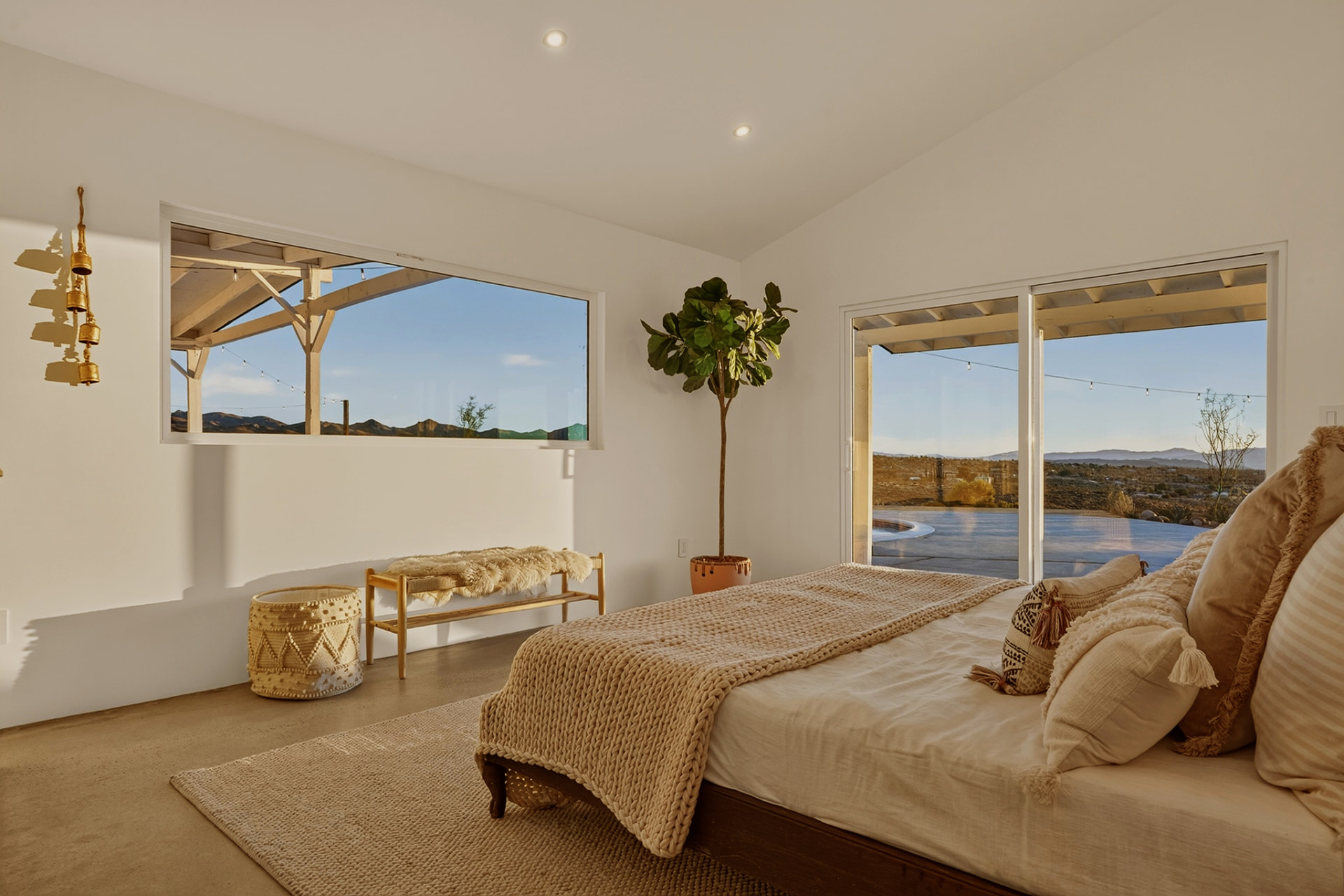 Primary bedroom with pool view and desert vista