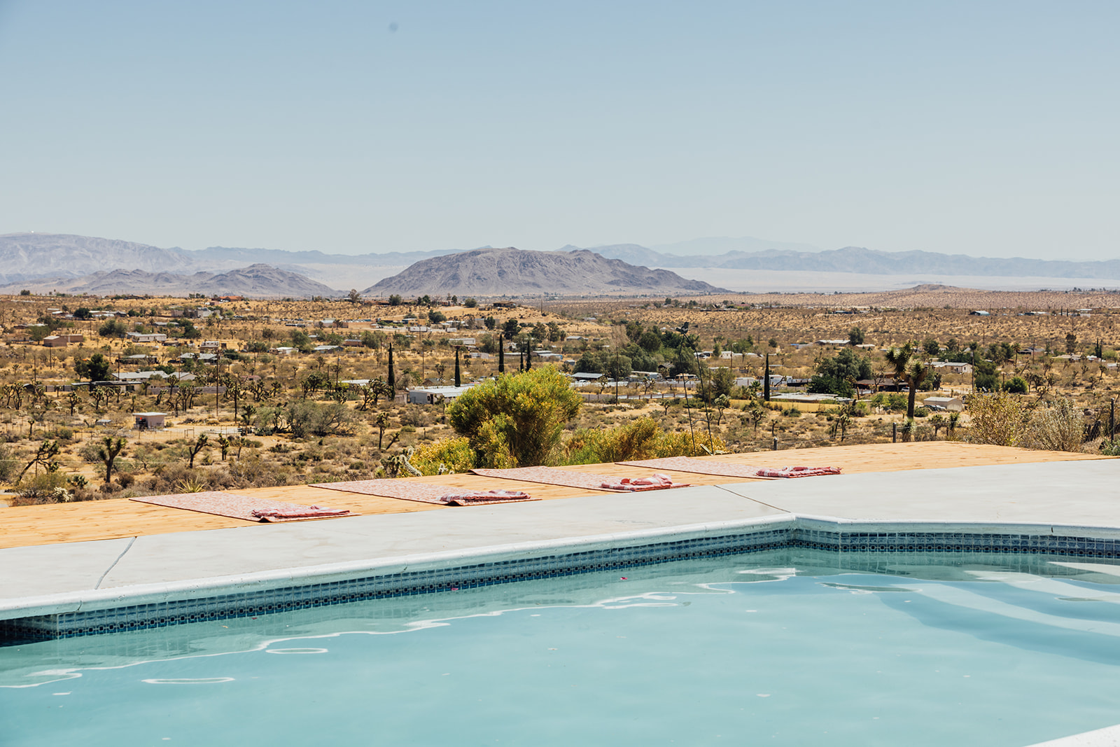 Pool and sun deck with sweeping views to distant mountain ranges