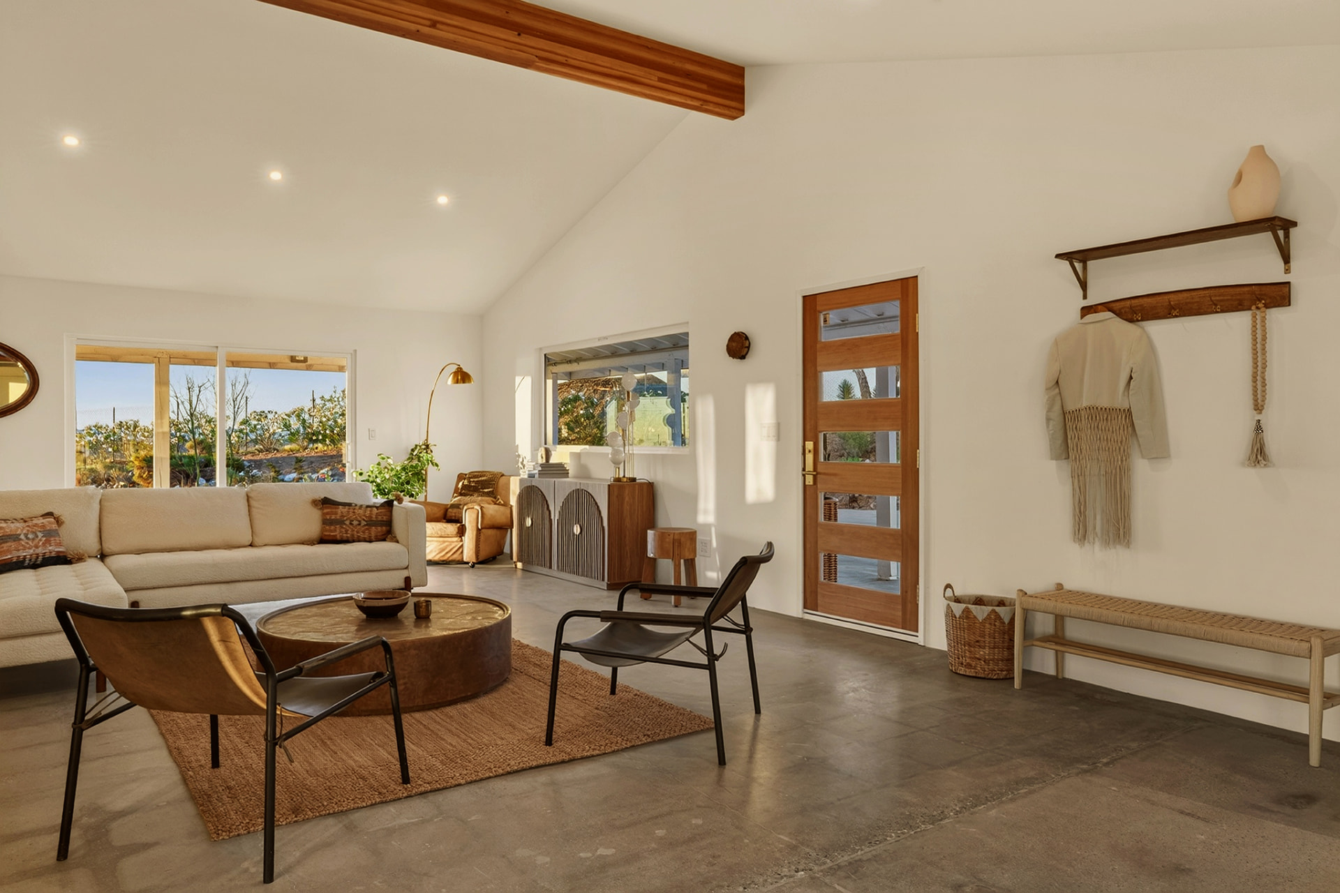 Living room with entry door, bench and coat hooks