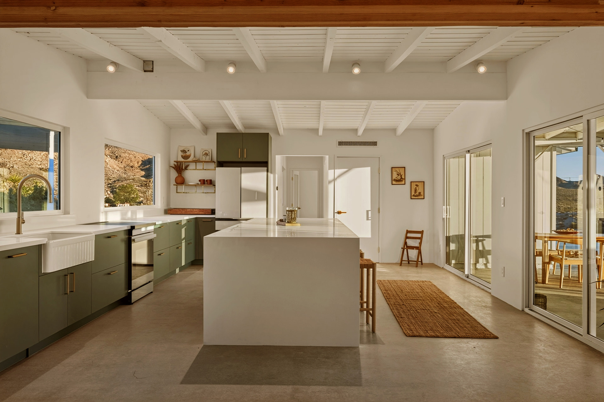 Open kitchen with farmhouse sink and morning light